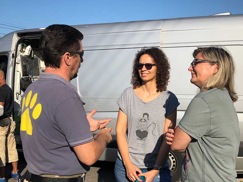 Akis, Sonia and her colleague chatting and deciding Grizzly would be happier travelling by air, so we transferred him from our van to the flight.