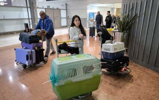 Posong and Eddie on arrival at Charles de Gaulle airport with the volunteer who accompanied them on their flight