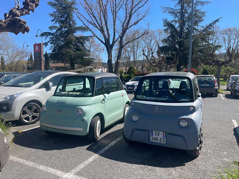 Almost twins! A Fiat Topolino and a Citroën Ami. These jaunty little electric vehicles are increasingly seen around French towns.